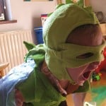 boy screaming, in dragon costume