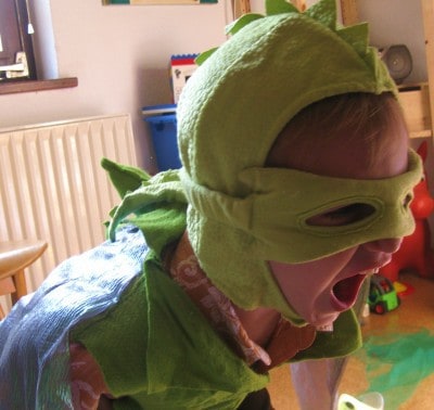 boy screaming, in dragon costume