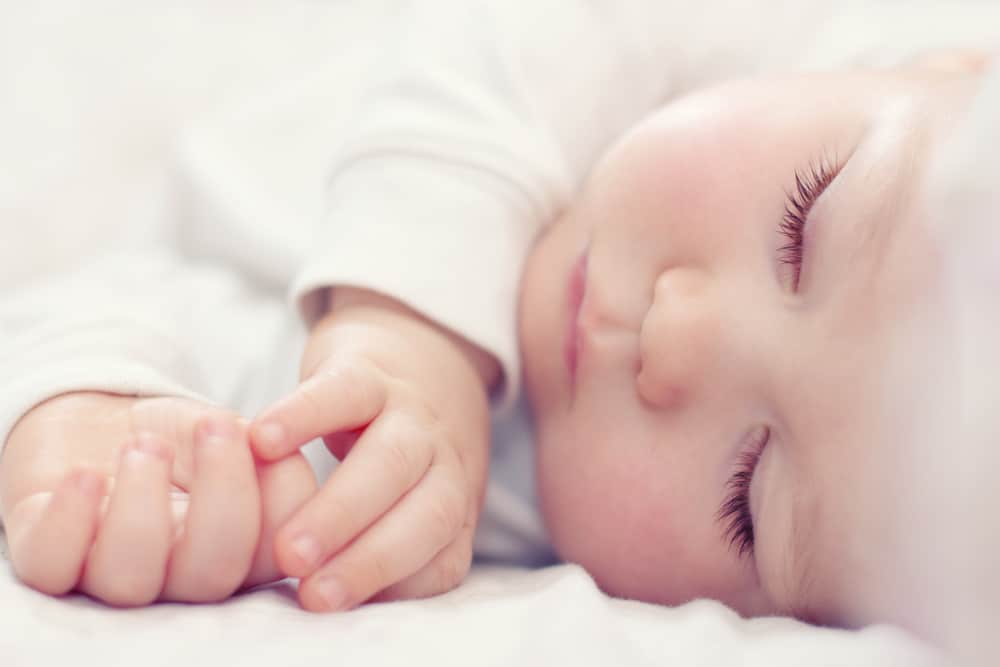 sleeping baby on bed